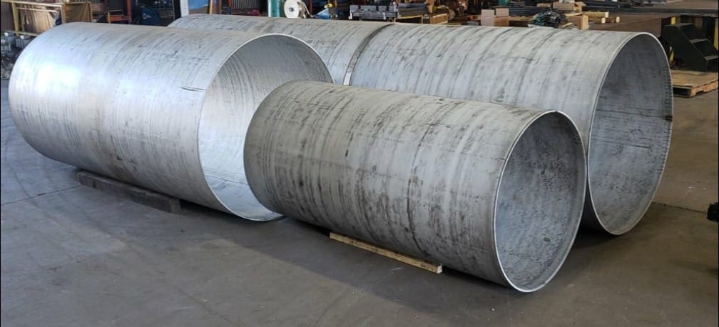 Metal cylinders on the shop floor being worked on.